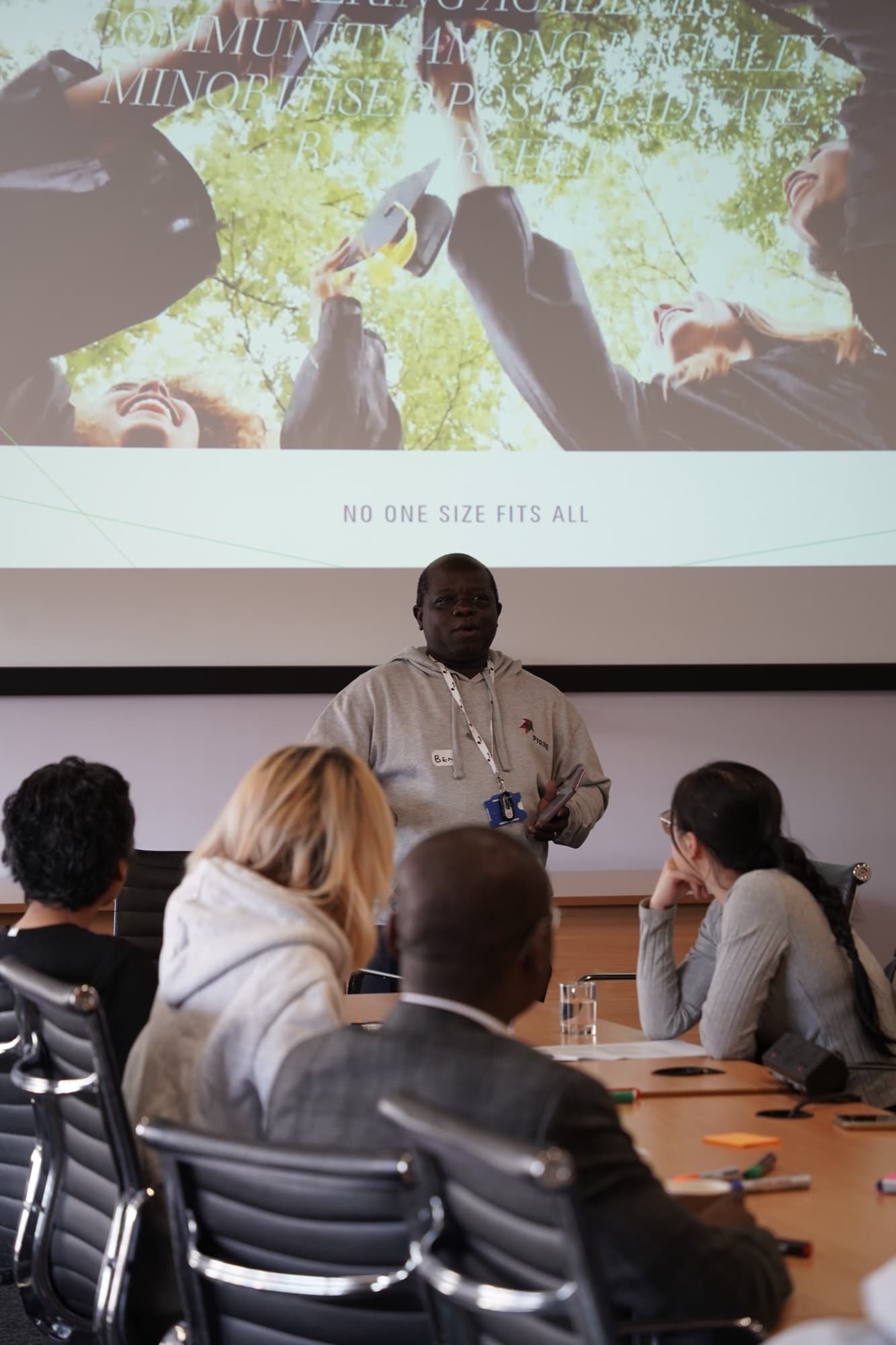Dr Ajibade delivering a keynote to a seated audience